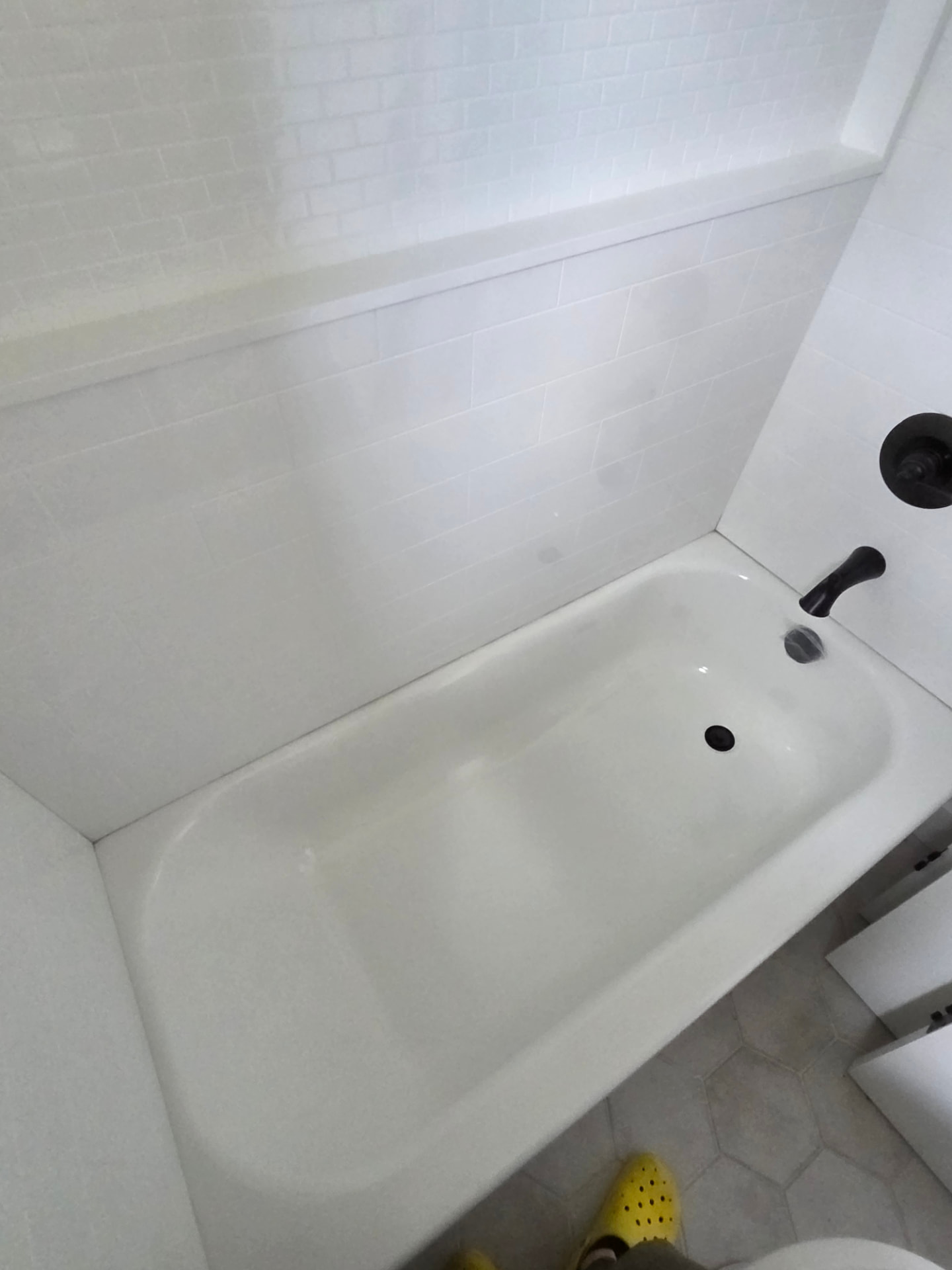 Bathtub before and after post-construction cleaning — after