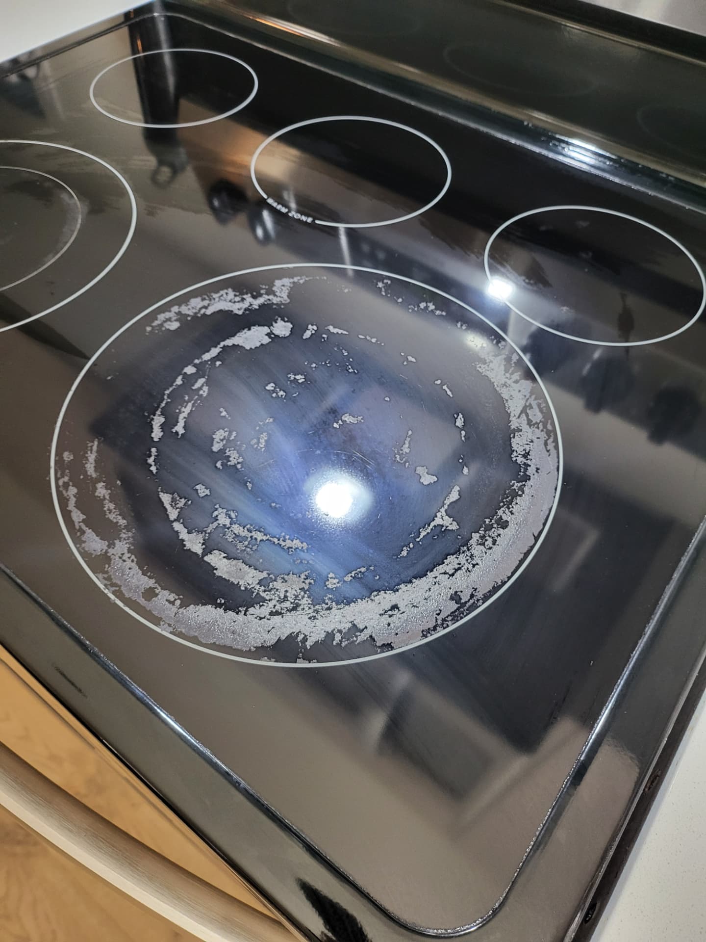 Glass cooktop before and after cleaning — before
