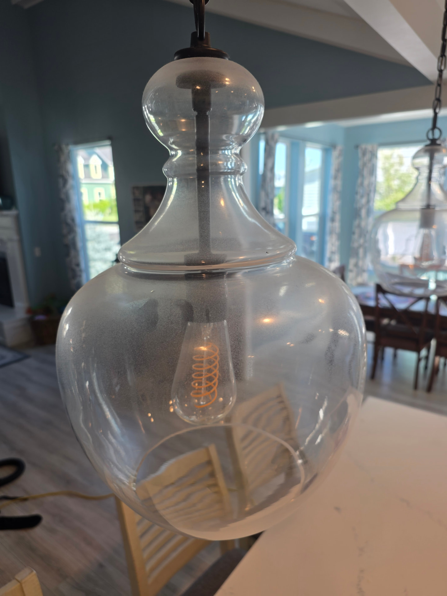 Glass pendant light before and after cleaning — before