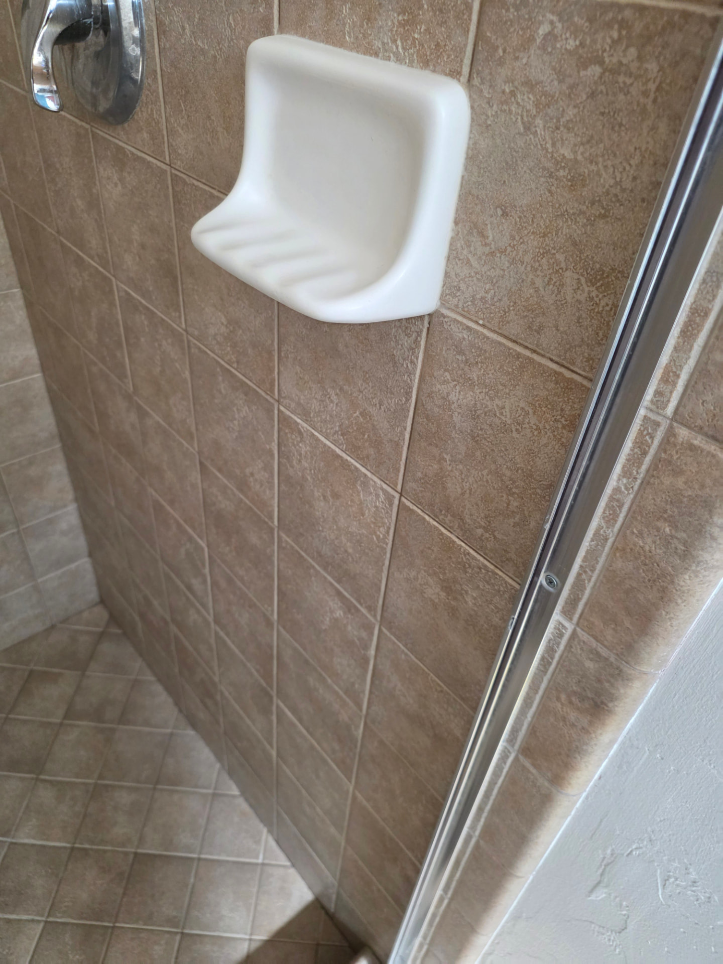 Tiled shower before and after deep cleaning — after